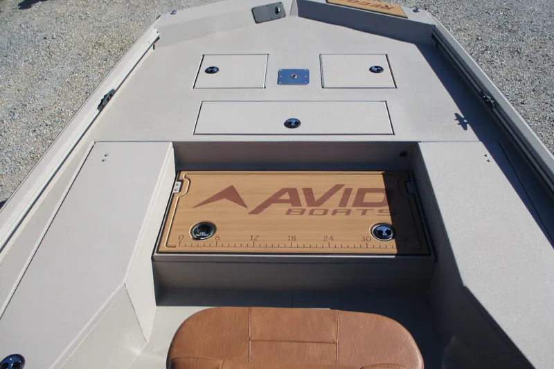 Slide: The Image of Avid 207 Recon boat interior, featuring storage compartments and branded deck, 2026 model. - 8