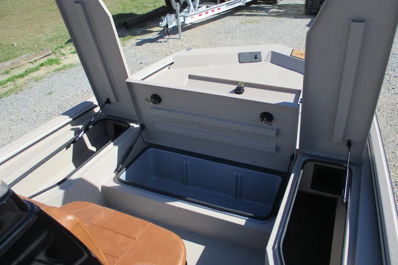 Slide: The Image of 2026 Avid 207 Recon boat interior with open storage compartments and seating. - 9