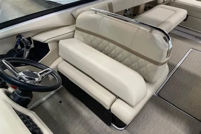 Slide: The Image of 2019 Regal 29 OBX boat interior with beige leather seating and steering wheel. - 10