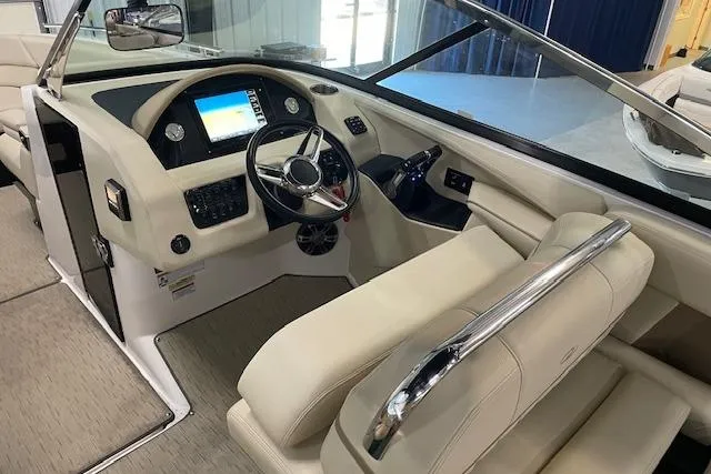 Slide: The Image of 2019 Regal 29 OBX boat interior with modern dashboard and beige seating. - 14