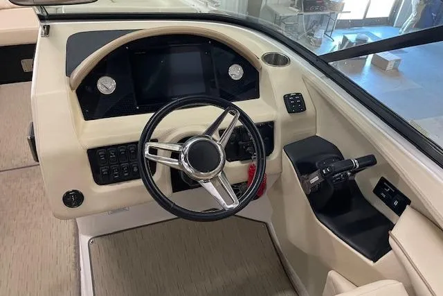 Slide: The Image of 2019 Regal 29 OBX boat dashboard with steering wheel and control panel. - 16