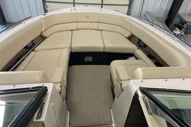 Slide: The Image of 2019 Regal 29 OBX boat interior with beige seating and spacious layout. - 7