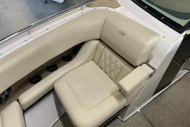 Slide: The Image of Luxurious seating on 2019 Regal 29 OBX boat with beige upholstery and cup holders. - 9