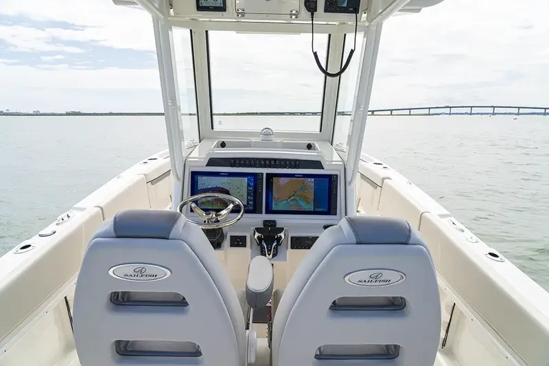 Slide: The Image of The image shows the cockpit of a Sailfish 252 CC boat with two screens and a steering wheel. - 30