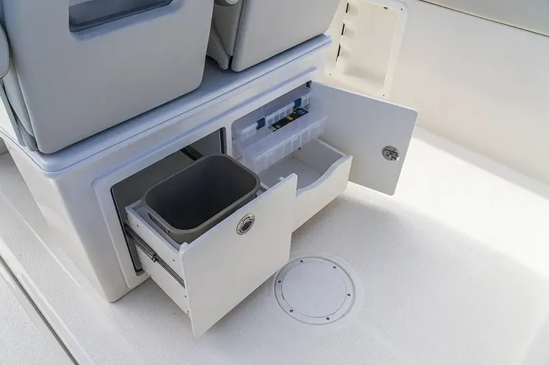 Slide: The Image of The image shows an open storage area on a boat with drawers and a trash bin. - 25