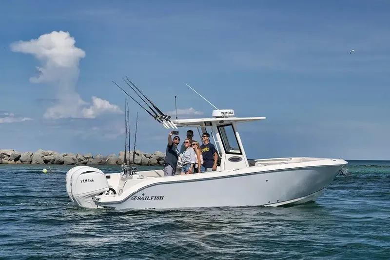 Slide: The Image of A 2026 Sailfish 252 CC on the water with several people on board. - 22
