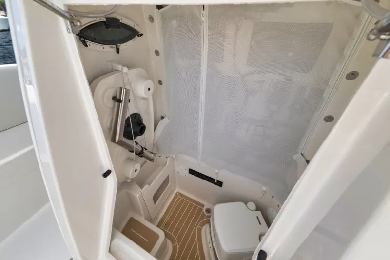 Slide: The Image of Interior of 2026 Sailfish 252 CC featuring toilet and storage. - 4