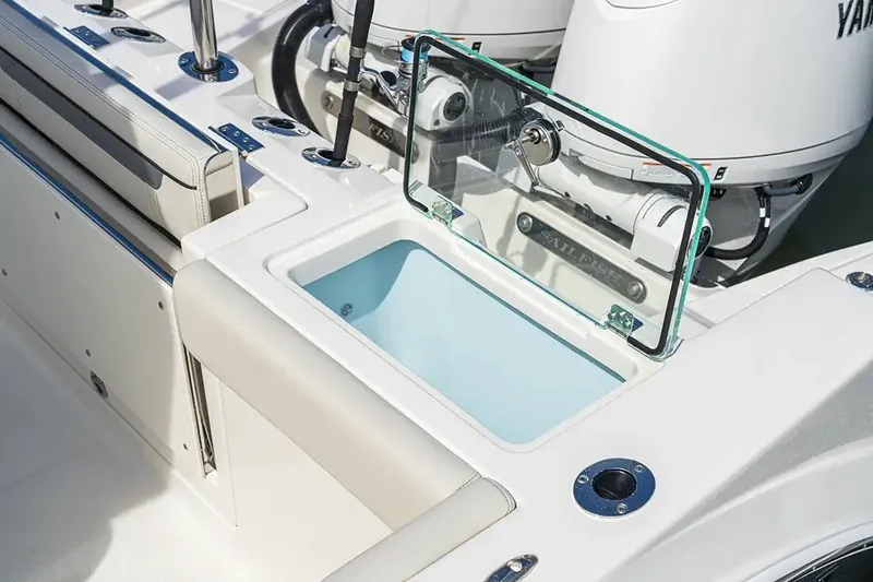 Slide: The Image of The image shows the cockpit of a Sailfish 252 CC boat with an open storage compartment. - 28