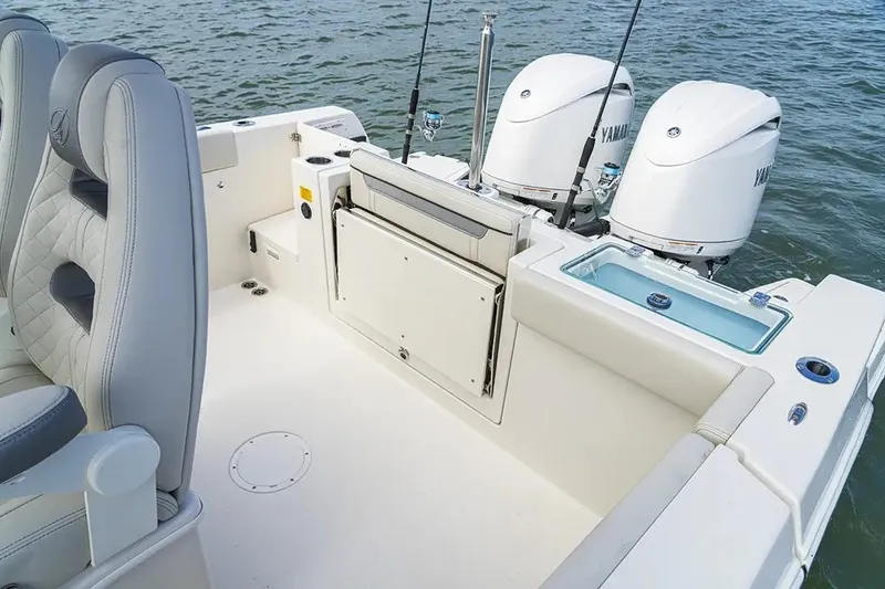 Slide: The Image of The image shows the stern of a Sailfish 252 CC boat with twin Yamaha outboard engines. - 26