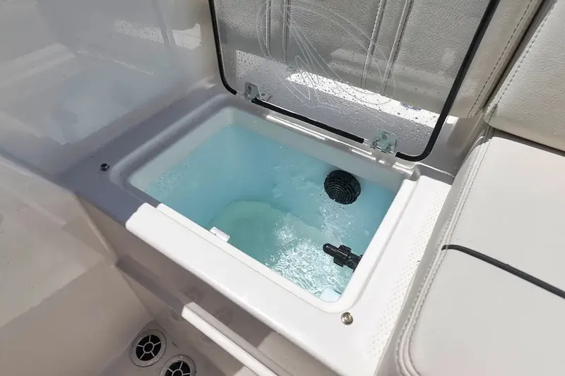 Slide: The Image of A livewell on a Sailfish 252 CC boat, filled with water, surrounded by white upholstery. - 14