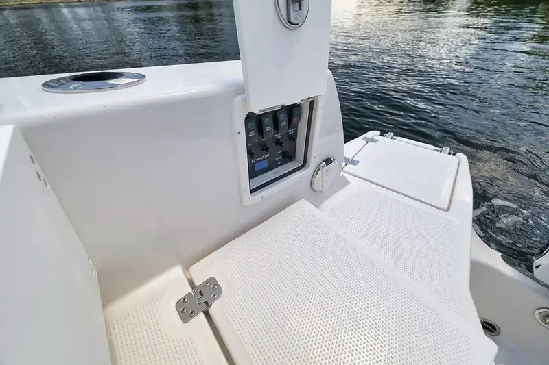 Slide: The Image of The image shows the deck of a Sailfish 252 CC boat with a control panel and water in the background. - 13
