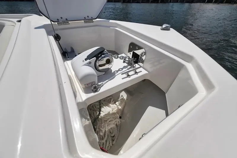 Slide: The Image of An open storage compartment on a boat reveals an anchor system and ropes. - 18