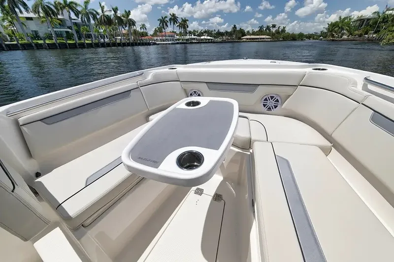 Slide: The Image of The image shows the bow area of a Sailfish 252 CC boat with a table and seating. - 17
