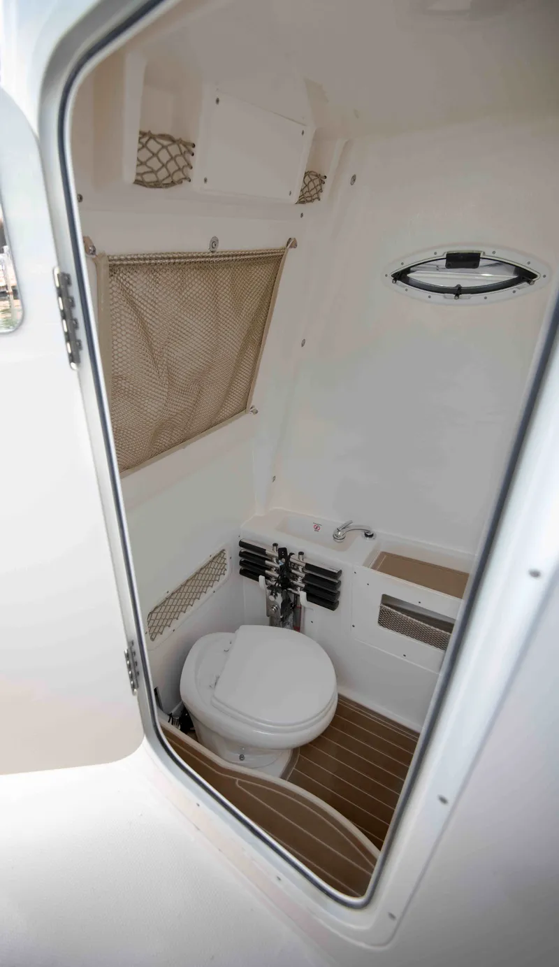 Slide: The Image of Interior of 2026 Sailfish 272 CC featuring toilet and storage. - 4