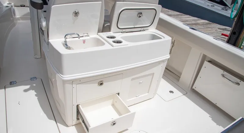 Slide: The Image of Interior of 2026 Sailfish 272 CC featuring sink and storage compartments. - 7