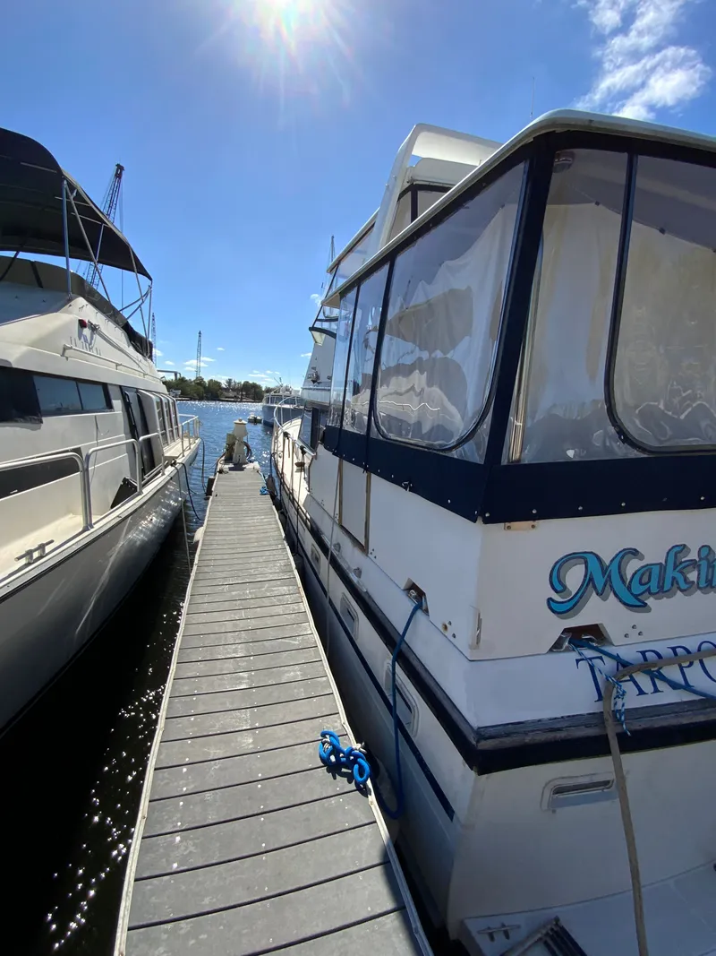 Slide: The Image of 1987 President 41 Double Cabin yacht docked under sunny skies. - 12