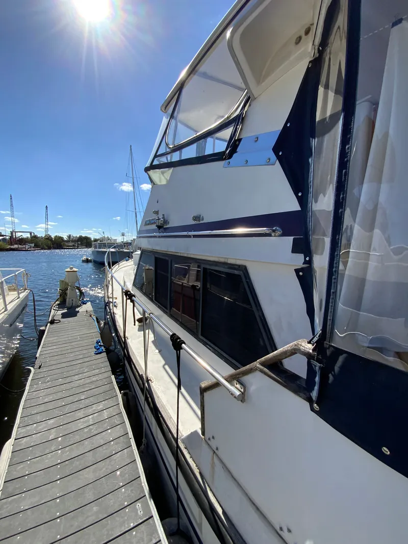 Slide: The Image of 1987 President 41 Double Cabin yacht docked under sunny skies. - 13