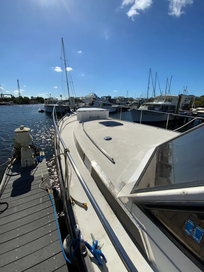 Slide: The Image of 1987 President 41 Double Cabin yacht docked under sunny skies. - 14