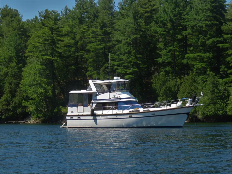 Slide: The Image of 1987 President 41 Double Cabin Yacht on a serene lake. - 3