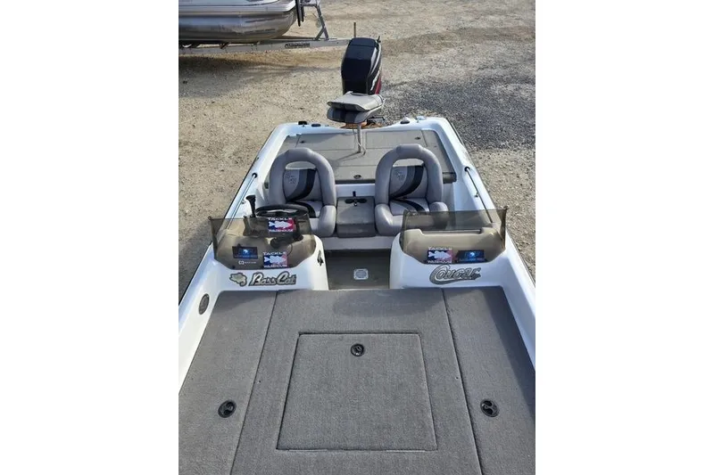Slide: The Image of 2001 Bass Cat Cougar boat interior with dual seats and steering console. - 12
