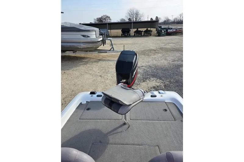 Slide: The Image of 2001 Bass Cat Cougar boat with motor, parked on gravel lot. - 13