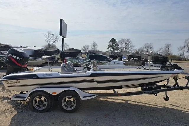 Slide: The Image of 2001 Bass Cat Cougar boat on trailer, parked outdoors, with Mercury engine. - 4