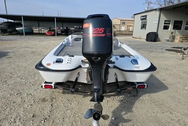 Slide: The Image of 2001 Bass Cat Cougar boat with Mercury 225 engine, parked outdoors. - 9