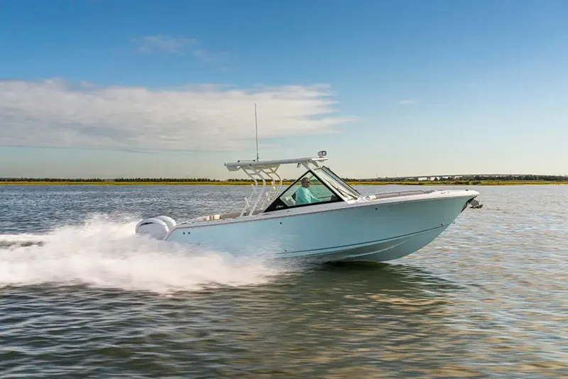 Slide: The Image of A modern motorboat speeding across calm water, with a clear sky in the background. - 2