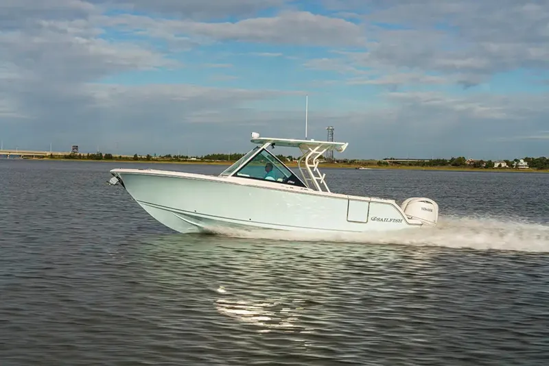 Slide: The Image of A modern motorboat speeding across calm water, with a clear blue sky in the background. - 1