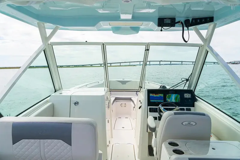 Slide: The Image of The cockpit of a modern sailboat with two seats, a helm, and a large display screen. - 5