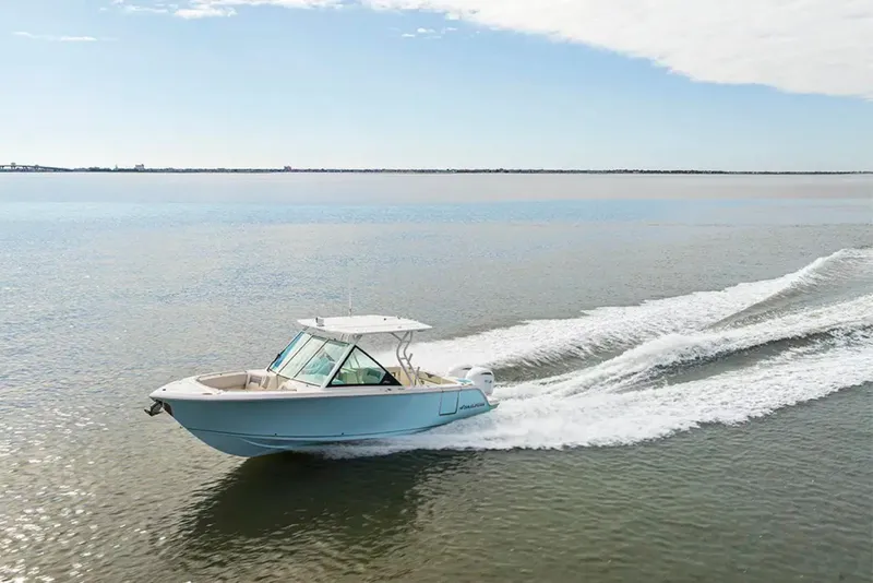 Slide: The Image of A modern motorboat speeding across calm waters, with a clear sky in the background. - 3