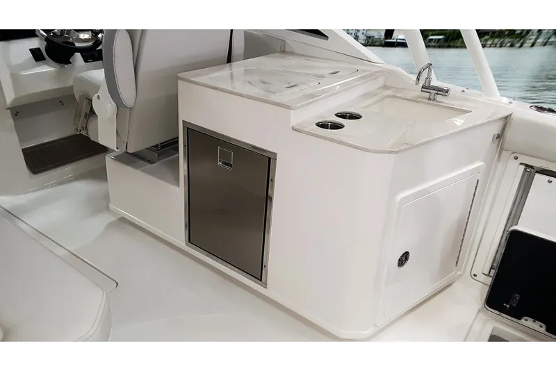 Slide: The Image of The 2026 Sailfish 276 DC features a compact onboard kitchenette with a sink and storage. - 11