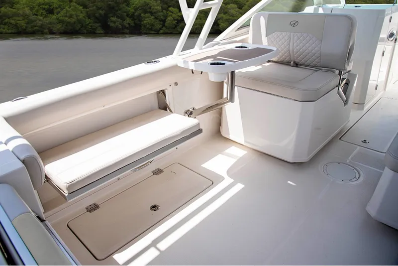 Slide: The Image of The image shows the cockpit of a Sailfish 276 DC boat with beige seating and a table. - 15