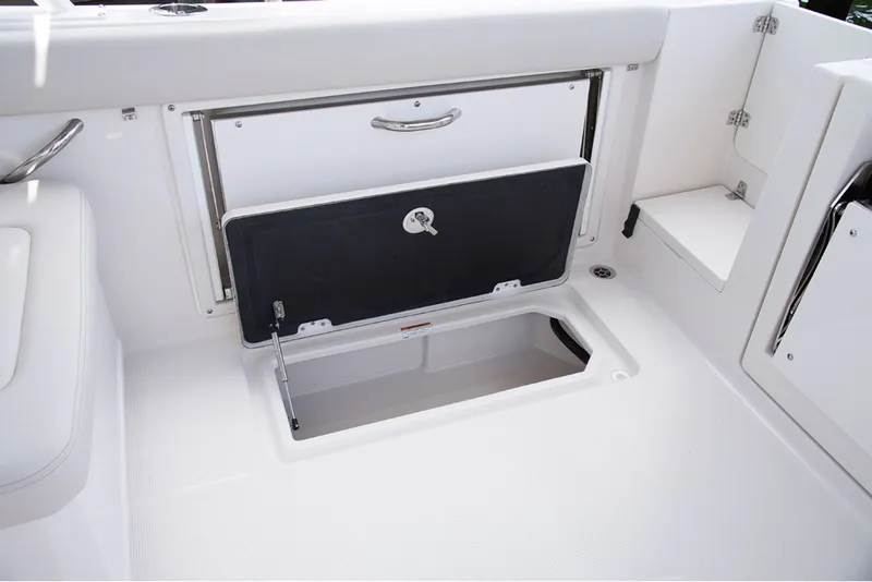 Slide: The Image of The image shows a storage compartment on a boat with an open hatch and a handle. - 13
