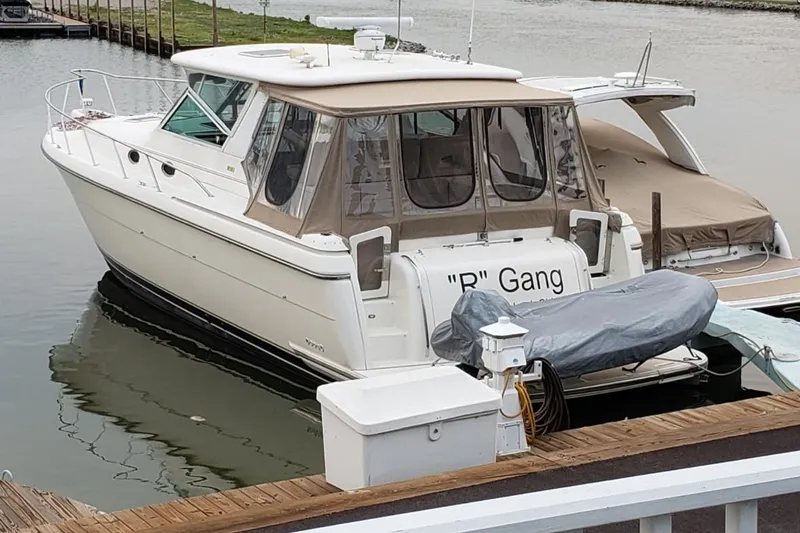 The Image of 1997 Tiara Yachts 4000 Express docked, featuring a covered deck and sleek design. - 0