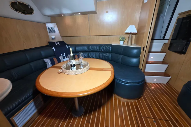 Slide: The Image of Luxurious 1997 Tiara Yachts 4000 Express interior with elegant seating and wooden finishes. - 13