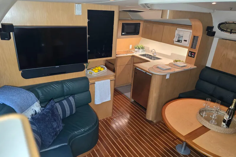 Slide: The Image of Luxurious interior of 1997 Tiara Yachts 4000 Express with modern kitchen and cozy seating. - 14