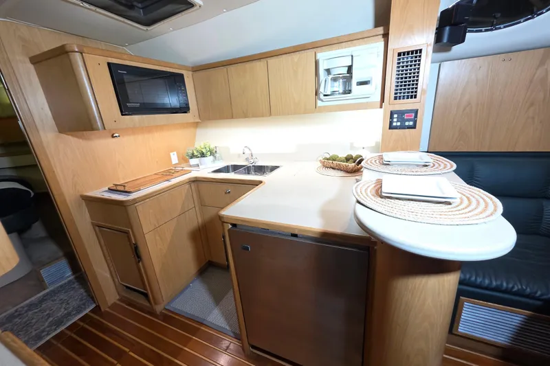 Slide: The Image of 1997 Tiara Yachts 4000 Express interior kitchen with wood cabinetry and modern appliances. - 16