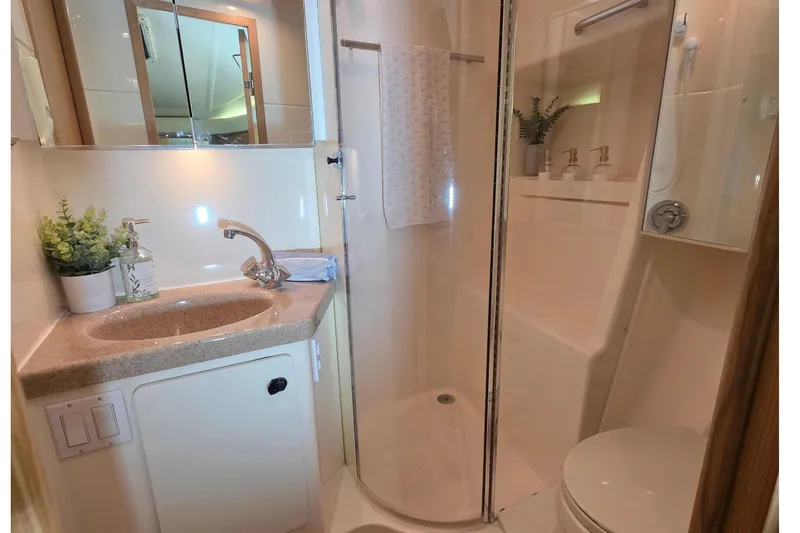 Slide: The Image of 1997 Tiara Yachts 4000 Express bathroom with shower and sink. - 20