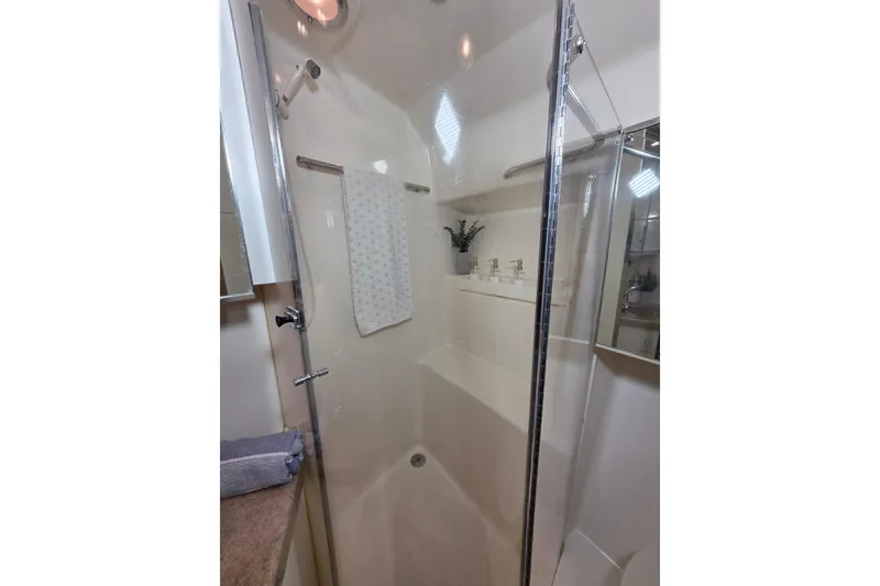 Slide: The Image of Shower area in 1997 Tiara Yachts 4000 Express, featuring glass door and modern fixtures. - 21