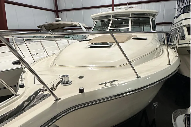 Slide: The Image of 1997 Tiara Yachts 4000 Express in storage, showcasing sleek design and polished railings. - 4