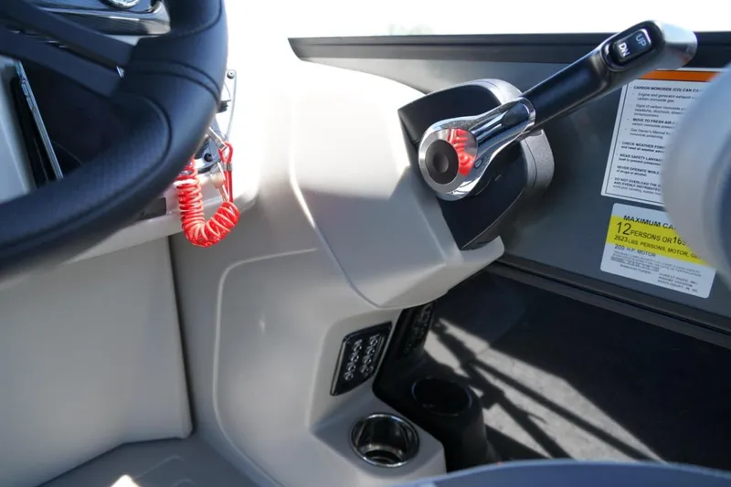 Slide: The Image of Steering console of 2026 Berkshire 24 RFX LE boat with throttle and safety features. - 10