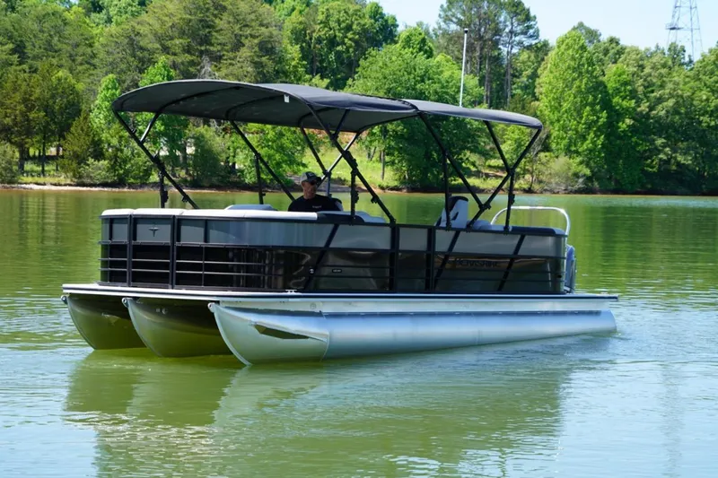 Slide: The Image of 2026 Berkshire 24 RFX LE pontoon boat on a serene lake. - 2