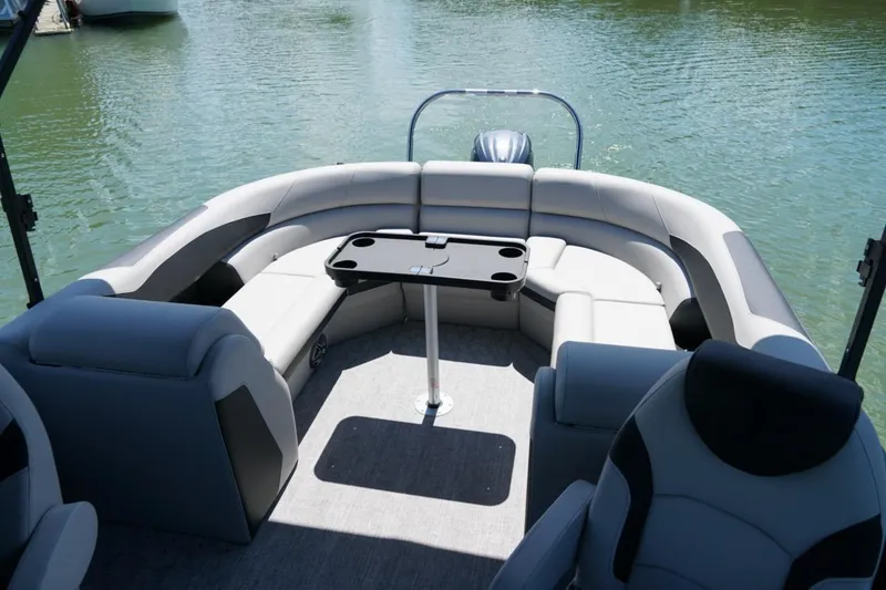 Slide: The Image of Interior of 2026 Berkshire 24 RFX LE pontoon boat with plush seating and table. - 7