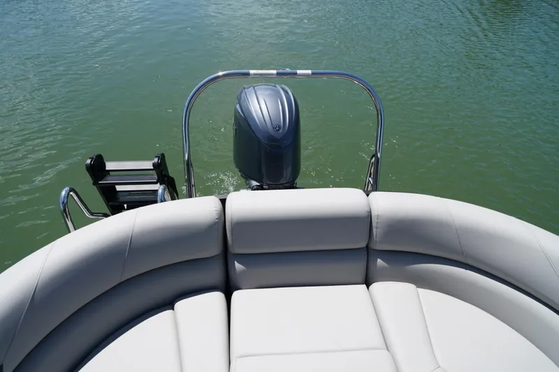 Slide: The Image of 2026 Berkshire 24 RFX LE pontoon boat with outboard motor on calm water. - 8