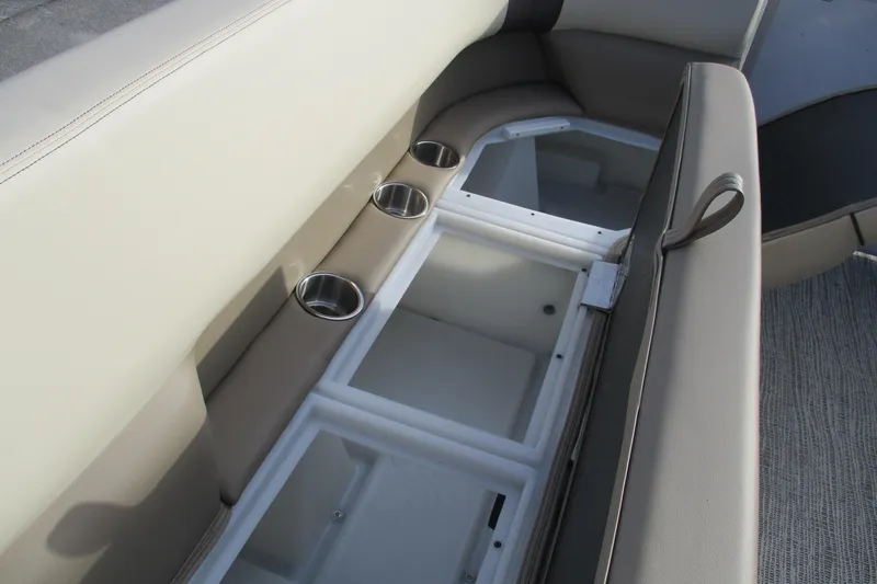 Slide: The Image of SunCatcher Select 22SL 2026 boat interior with storage compartments and cup holders. - 12