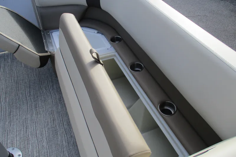 Slide: The Image of 2026 SunCatcher Select 22SL boat interior with storage and cup holders. - 16