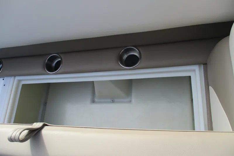 Slide: The Image of Interior storage compartment of 2026 SunCatcher Select 22SL boat with cup holders. - 17