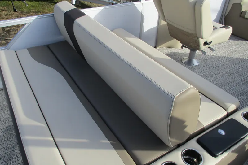Slide: The Image of 2026 SunCatcher Select 22SL boat interior with beige seating and cup holders. - 21