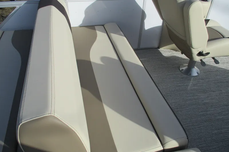 Slide: The Image of SunCatcher Select 22SL 2026 boat interior with beige seating and carpeted flooring. - 22